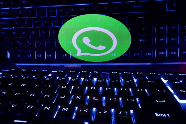 A keyboard is placed in front of a displayed WhatsApp logo in this illustration taken February 21, 2023. REUTERS/Dado Ruvic/Illustration/File Photo