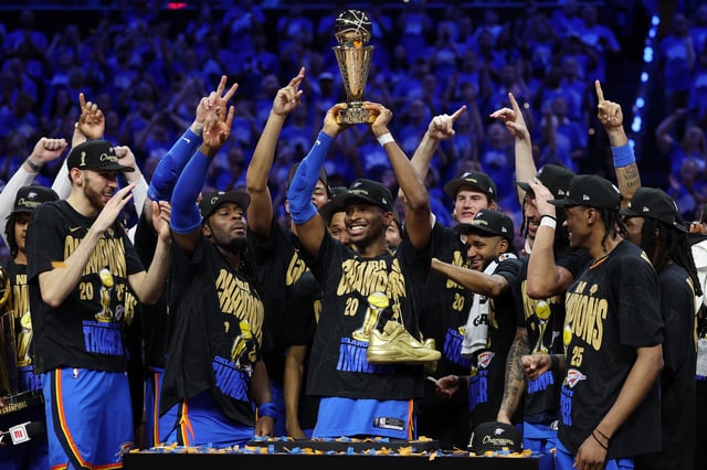 OKLAHOMA CITY, OKLAHOMA - JUNE 22: Shai Gilgeous-Alexander #2 of the Oklahoma City Thunder celebrates with the Bill Russell NBA Finals Most Valuable Player trophy after defeating the Indiana Pacers 103-91 in Game Seven of the 2025 NBA Finals at Paycom Center on June 22, 2025 in Oklahoma City, Oklahoma.