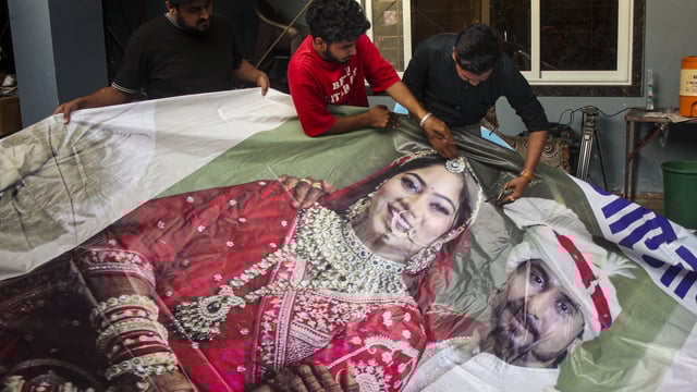 Family members of Raja Raghuvanshi, who was allegedly murdered during his honeymoon in Meghalaya, cut out the picture of his wife Sonam Raghuvanshi from a poster of their marriage 