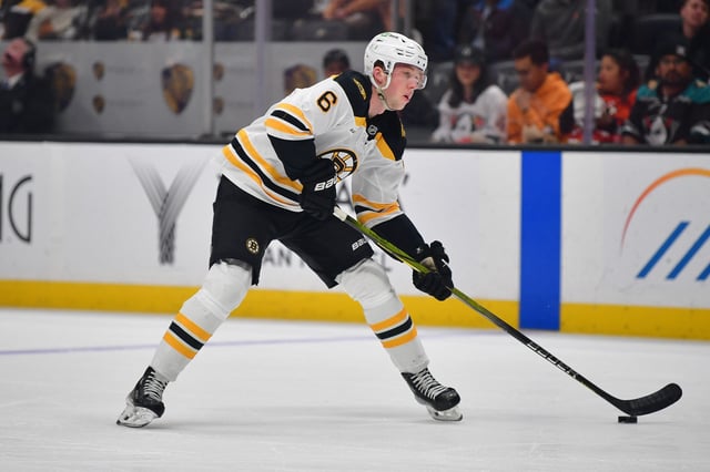 Mar 26, 2025; Anaheim, California, USA; Boston Bruins defenseman Mason Lohrei (6) controls the puck against the Anaheim Ducks during the first period at Honda Center. Mandatory Credit: Gary A. Vasquez-Imagn Images