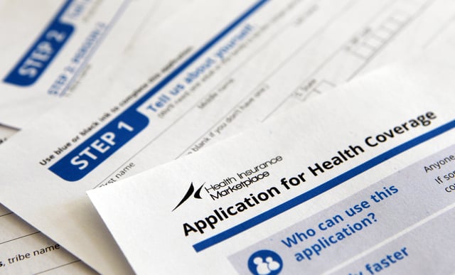 File photo: application and instructions paper work for the Health Insurance Marketplace from the Department of Health and Human Services.
