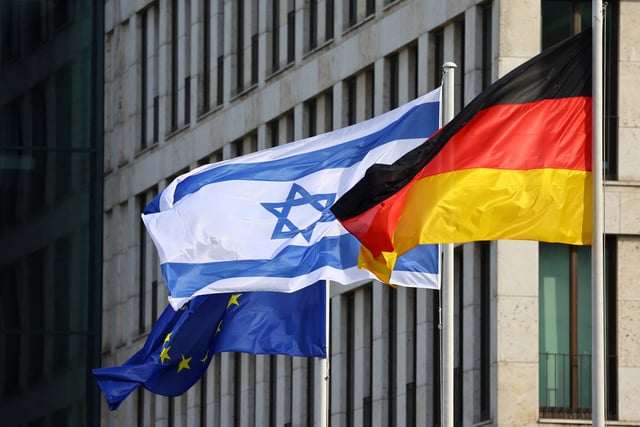 European Union, Israeli and German flags flutter near the Brandenburg Gate in Berlin, Germany, September 5, 2022. REUTERS/Fabrizio Bensch/File Photo