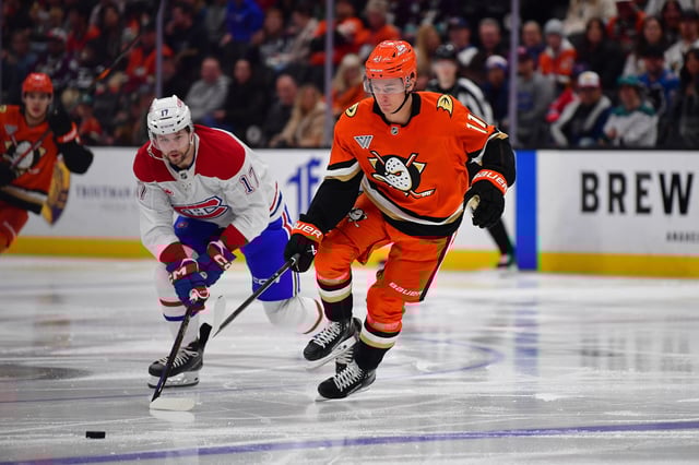 Feb 2, 2025; Anaheim, California, USA; Anaheim Ducks center Trevor Zegras (11) moves in for the puck against Montreal Canadiens right wing Josh Anderson (17) during the second period at Honda Center. Mandatory Credit: Gary A. Vasquez-Imagn Images