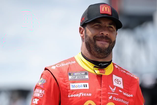 Bubba Wallace, driver of the #23 McDonald&#39;s Toyota, walks the grid during qualifying for the NASCAR Cup Series The Great American Getaway 400 at Pocono Raceway on June 21, 2025 in Long Pond, Pennsylvania.
