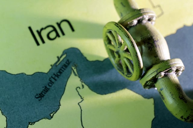 A map showing the Strait of Hormuz and Iran is seen behind a 3D printed oil pipeline in this illustration taken June 22, 2025. REUTERS/Dado Ruvic/Illustration