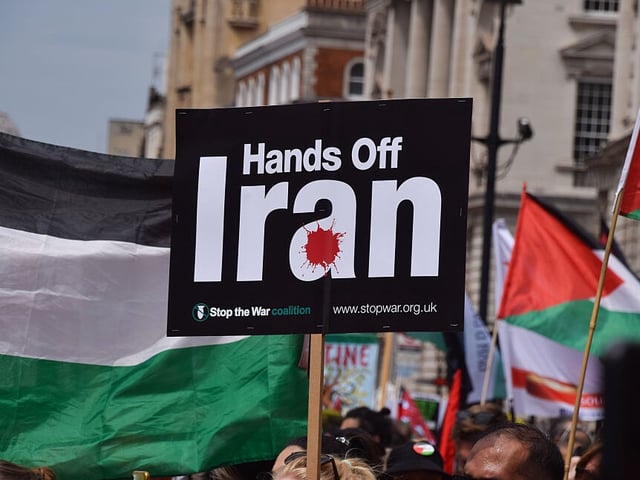 LONDON, UNITED KINGDOM - 2025/06/21: A protester holds a 'Hands Off Iran' placard during the demonstration in Whitehall. Tens of thousands of people marched in central London in support of Palestine and in protest against bombing Iran, as Israel continues its attacks on Gaza and launches attacks on Iran. (Photo by Vuk Valcic/SOPA Images/LightRocket via Getty Images)