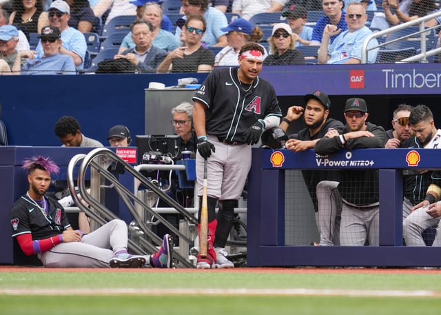 TORONTO, ON - JUNE 19: Lourdes Gurriel Jr. #12 and Josh Naylor #22 of the Arizona Diamondbacks look on from the dugout as their team plays the Toronto Blue Jays in their MLB game at the Rogers Centre on June 19, 2025 in Toronto, Ontario, Canada.