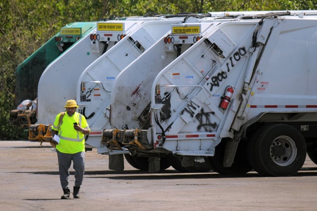 A worker returns from his vehicle in a view from outside of The Reedbird Ave. DPW site, where Ronald Silver II worked before he died. (Karl Merton Ferron/Staff)