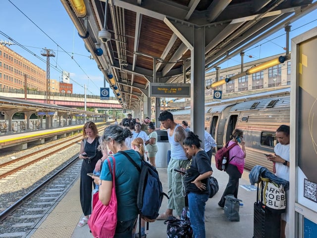 Passengers wait on a platform at Penn Station for a transfer train after Train 94’s malfunction left them stranded in a tunnel. (Miriam Torrey-Coffidis/Courtesy)