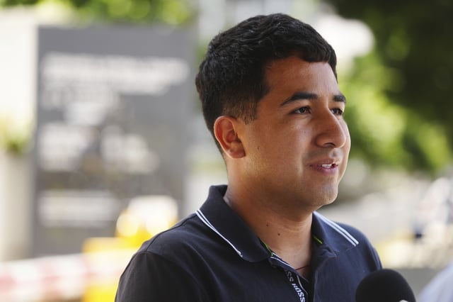 Alejandro Barranco conducts an interview as he arrives to check on his father Narciso, who was detained by federal agents, outside the Metropolitan Detention Center on Monday, June 23, 2025, in Los Angeles. (AP Photo/Damian Dovarganes)