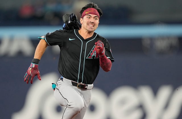 Arizona Diamondbacks right fielder Corbin Carroll (7) loses his helmet as he runs to third base on a triple against the Toronto Blue Jays during the sixth inning at Rogers Centre in Toronto, Ontario, on June 18, 2025.