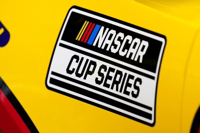 FILE – A NASCAR logo is seen on a car during auto race practice at Daytona International Speedway, Saturday, Feb. 19, 2022, in Daytona Beach, Fla. Teams report to Daytona International Speedway this week to prepare for Sunday’s season-opening Daytona 500 without a new revenue sharing agreement that has been an ongoing sore spot between both NASCAR and its participants. (AP Photo/John Raoux, File)