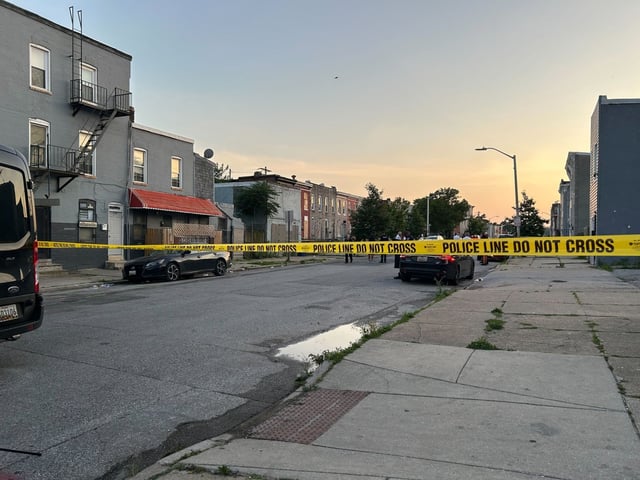 Police tape closes off the intersection of South Monroe and McHenry streets as Baltimore Police investigate a quadruple shooting. (Racquel Bazos/Staff)