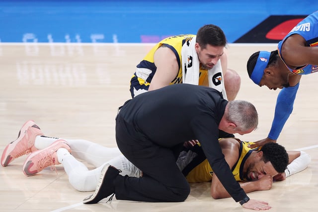 Tyrese Haliburton #0 of the Indiana Pacers sustains an injury during the first quarter as Shai Gilgeous-Alexander #2 of the Oklahoma City Thunder checks on him in Game Seven of the 2025 NBA Finals at Paycom Center on June 22, 2025 in Oklahoma City, Oklahoma.