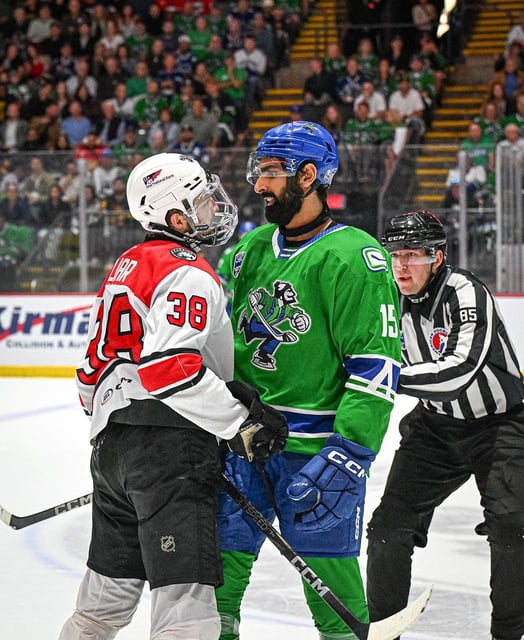  Jujhar Khaira of The Abbotsford Canucks sizes up Oliver Okuliar.