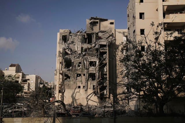 Israeli soldiers and a rescue team search for survivors amid the rubble of residential buildings destroyed by an Iranian missile strike that killed several people, in Beersheba, Israel, on Tuesday, June 24, 2025. (AP Photo/Leo Correa)