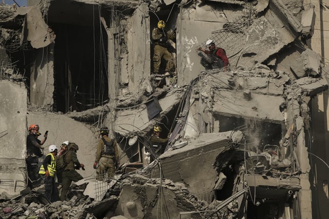 Israeli soldiers and rescue team search for survivors amid the rubble of residential buildings destroyed by an Iranian missile strike that killed several people, in Beersheba, Israel, on Tuesday, June 24, 2025. (AP Photo/Leo Correa)