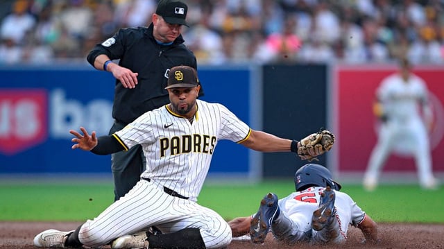Daylen Lile (51) of the Washington Nationals slides past Xander Bogaerts (2) of the San Diego Padres before being tagged out attempting to steal second base in the third inning at Petco Park on Monday, June 23, 2025, in San Diego. (Orlando Ramirez/Getty Images/TNS)