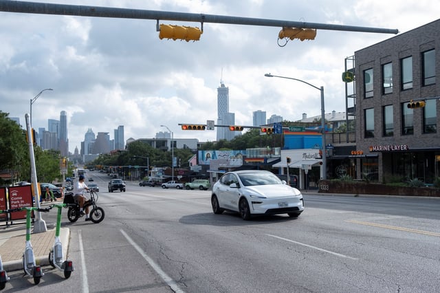 A Tesla robotaxi drives on the street along South Congress Avenue in Austin, Texas, U.S., June 22, 2025. REUTERS/Joel Angel Juarez/File Photo