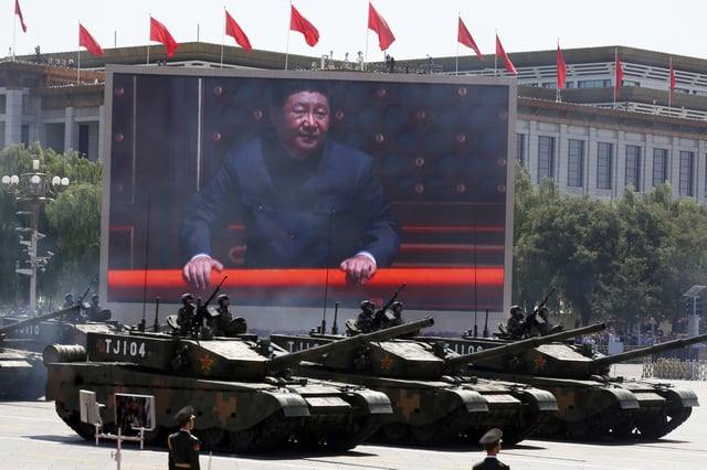 FILE - Chinese President Xi Jinping is displayed on a screen as Type 99A2 Chinese battle tanks take part in a parade commemorating the 70th anniversary of Japan's surrender during World War II held in front of Tiananmen Gate in Beijing on Sept. 3, 2015. (AP Photo/Ng Han Guan, File)