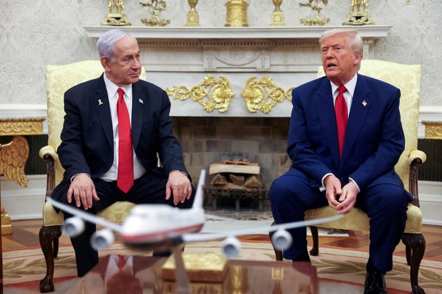 FILE PHOTO: U.S. President Donald Trump talks to Israeli Prime Minister Benjamin Netanyahu during a meeting where Trump announced nuclear talks with Iran, Washington, U.S., April 7, 2025. REUTERS/Kevin Mohatt/File Photo/File Photo