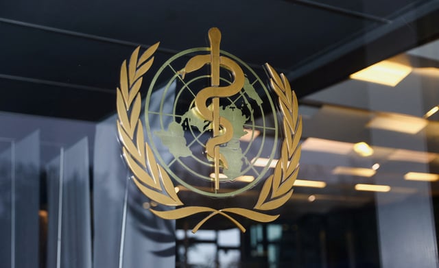 The World Health Organization logo is pictured at the entrance of the WHO building, in Geneva, Switzerland, December 20, 2021. REUTERS/Denis Balibouse/File Photo