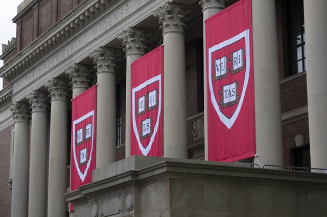 Harvard banners hang in front of Widener Library during the 374th Harvard Commencement in Harvard Yard in Cambridge, Massachusetts, on May 29, 2025.