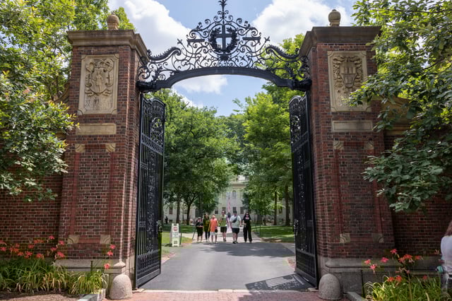 People walk through the gate on Harvard Yard at the Harvard University campus on June 29, 2023 in Cambridge, Massachusetts.
