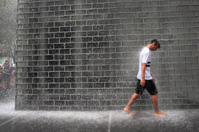 CHICAGO, ILLINOIS  – JULY 19: A visitor cools off in Crown Fountain in downtown as temperatures are forecast to head into the mid to high 90’s with a heat index of around 115 degrees on July 19, 2019 in Chicago, Illinois. The heat wave gripping the city is affecting nearly two-thirds of the United states where more than 195 million people will experience temperatures above 90 degrees over the next few days.  (Photo by Scott Olson/Getty Images)