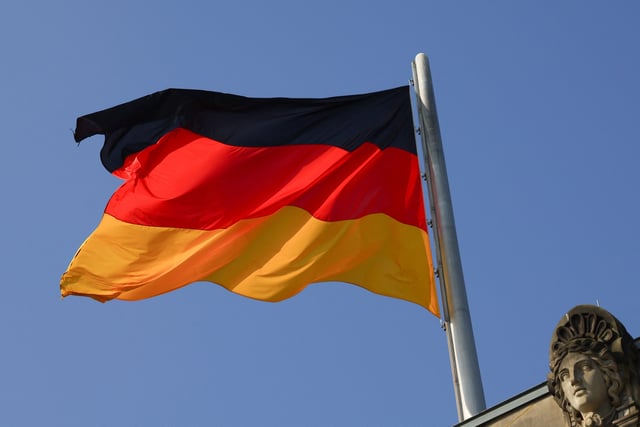 German national flag flutters on top of the Reichstag building, that seats the Germany's lower house of parliament, the Bundestag, in Berlin, Germany, March 25, 2025. REUTERS/Lisi Niesner/ File Photo