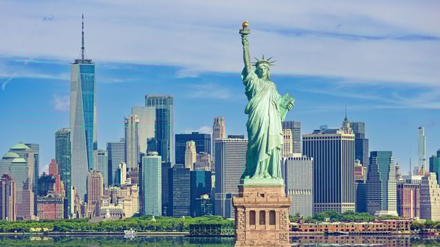 Statue of Liberty and New York City Skyline with Manhattan Financial District, World Trade Center, Empire State Building and Blue Sky. stock photo