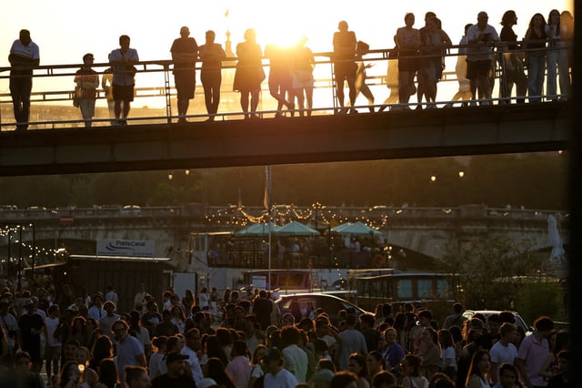 Music enthusiasts gather for free concerts on the banks of the Seine river during France's annual street music festival, the Fete de la Musique, in Paris on June 21, 2025. 