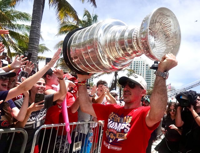 Brad Marchand of the Florida Panthers hoists the Stanley Cup in front of the crowd along the 2025 championship parade route on Fort Lauderdale beach on Sunday, June 22, 2025. (Joe Cavaretta/South Florida Sun Sentinel)