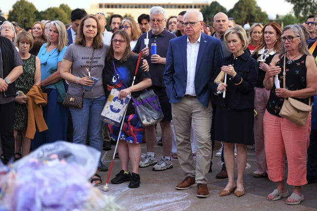 Minnesota Gov. Tim Walz and his wife Gwen Walz attend a candlelight vigil for former House Speaker Melissa Hortman and her husband, Mark, at the State Capitol, Wednesday, June 18, 2025, in St. Paul, Minn. (AP Photo/Nikolas Liepins)