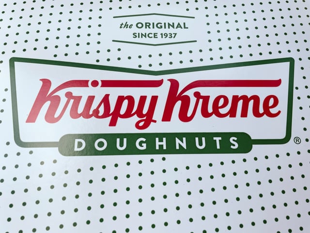 A Krispy Kreme Doughnuts logo is pictured in Burbank, California, U.S., July 1, 2021. REUTERS/Mario Anzuoni/File Photo