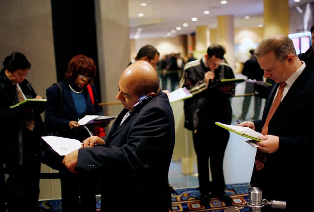 People wait on line for a job fair sponsored by employment website Monster.com as part of their "Keep America Working" tour at a hotel in New York's Times Square, March 5, 2009. REUTERS/Mike Segar/File Photo