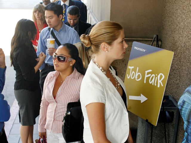 Bridget Dougherty (R) waits in line to enter a Monster.com job fair in Los Angeles, California July 23, 2008. REUTERS/Fred Prouser/File Photo