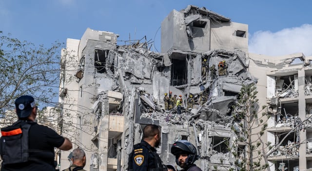 Search and rescue teams conduct operations at a building in Beersheba, Israel that was heavily damaged and partially collapsed by a missile fired from Iran early Tuesday morning, June 24, 2025. Four people died in the attack, which reportedly came hours before a U.S.-brokered ceasefire was set to go into effect. (Mostafa Alkharouf/Anadolu via Getty Images)