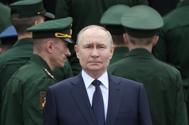 Russian President Vladimir Putin, surrounded by armed forces&#39;s officers, attends a wreath laying ceremony to the Unknown Soldier&#39;s Tomb in the Alexander Garden along the Kremlin wall on June 22, 2025 in Moscow, Russia.