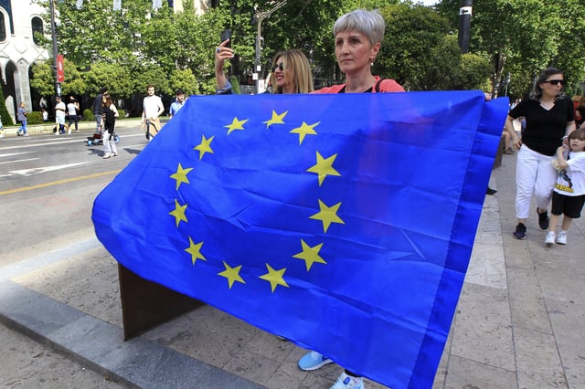 A woman holds an EU flag during an opposition rally marking the Independence Day in Tbilisi, Georgia, Monday, May 26, 2025. (AP Photo/Shakh Aivazov)