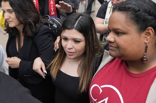Jennifer Vasquez Sura, wife of Kilmar Abrego Garcia, center, is escorted out of the Federal Courthouse on Friday, June 13, 2025, in Nashville, Tenn. (AP Photo/George Walker IV)