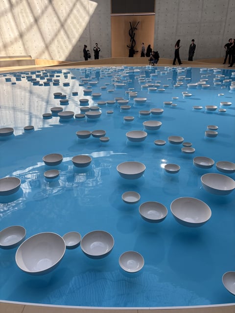 A pool filled with floating porcelain bowls set the scene for Saint Laurent’s show at Paris Fashion Week Men’s S/S 2026