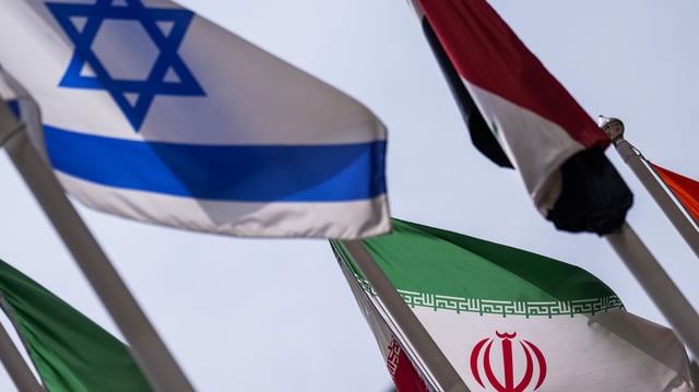 The flags of Israel and Iran fly outside the International Atomic Energy Agency's headquarters in Vienna, Austria on June 23. Photo: Christian Bruna/Getty Images