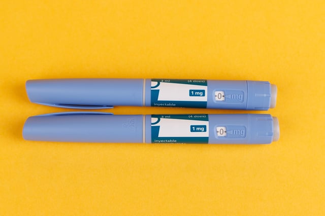Medication pens for glucose control with semaglutide displayed on a vibrant yellow background, photographed in a top-down view