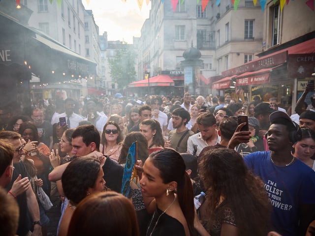 PARIS, FRANCE - JUNE 21: Revellers dance in the street during Fete De La Musique 2025 as bands and DJ's play on streets across the French capital on June 21, 2025 in Paris, France. Launched in 1982 by the French Ministry of Culture with the aim of creating a revolution in music culture by making all genres of music accessible to everyone, Fête de la Musique is now celebrated on Summer Solstice in eighty-five countries on five continents across the world. (Photo by Kiran Ridley/Getty Images)