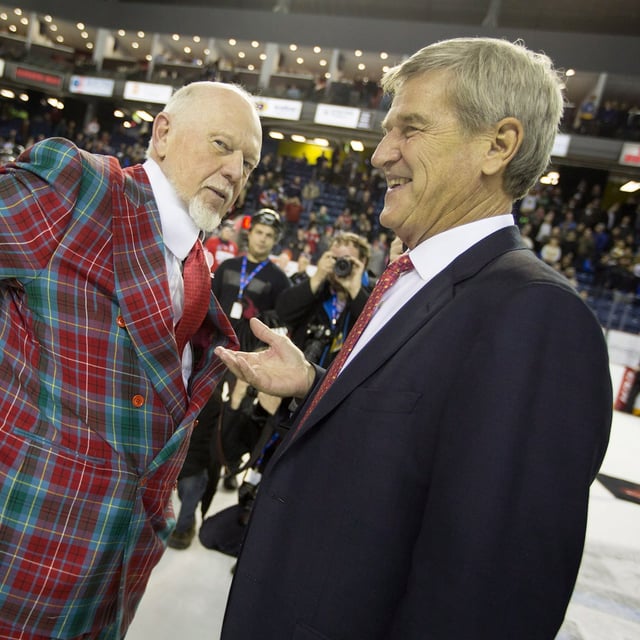 Don Cherry reaches into his pocket to pay $100 to Bobby Orr to settle their traditional bet on the game following the Top Prospects game in St. Catharine's, Ont., on Thursday, Jan. 22, 2015. Team Orr won 6-0, and so Don Cherry paid Bobby Orr $100 after shaking hands after the game. THE CANADIAN PRESS/Peter Power