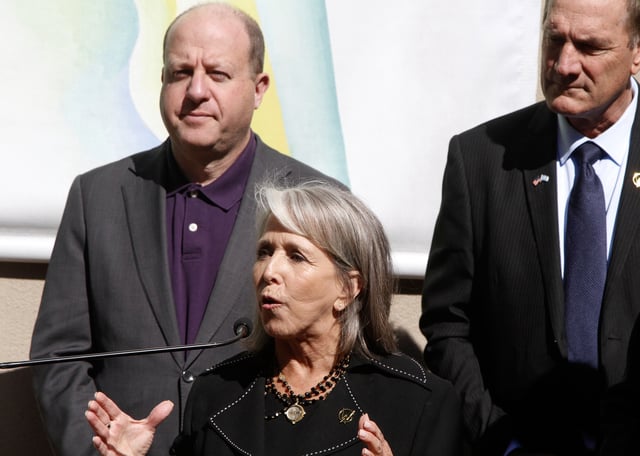 CAPTION CORRECTS THE ID - Governor Michelle Lujan Grisham of New Mexico, center, watched by Governors Larry Rodin of South Dakota, right, and Jared Polis of Colorado, talks about priorities for affordable housing and public lands in Santa Fe, N.M., on Monday, June 23, 2025, at a meeting of the Western Governor's Association. (AP Photo/Morgan Lee)