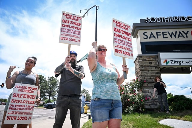Managers Tori (no last name provided), Michael (no last name provided) and Denise (no last name provided) holds signs during a protest against Safeway in Littleton, Colorado on Monday, June 16, 2025. (Photo by AAron Ontiveroz/The Denver Post)