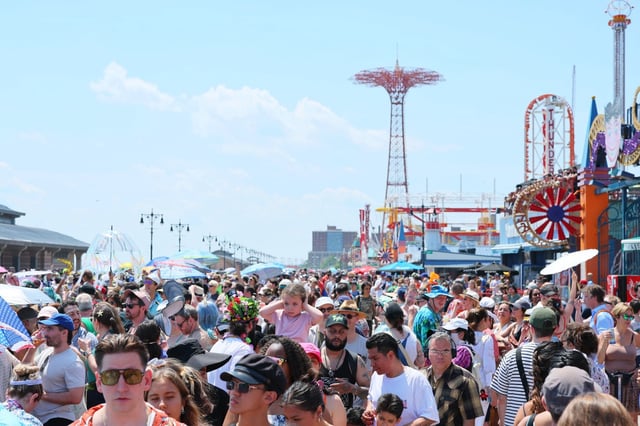 NEW YORK, NEW YORK - JUNE 21: People walk along the boardwalk during the 43rd annual Mermaid Parade at Coney Island on June 21, 2025 in New York City. The annual Mermaid Parade marks the beginning of summer in NYC and pays tribute to Coney Island’s Mardi Gras celebrations in the early 1900’s. (Photo by Michael M. Santiago/Getty Images)