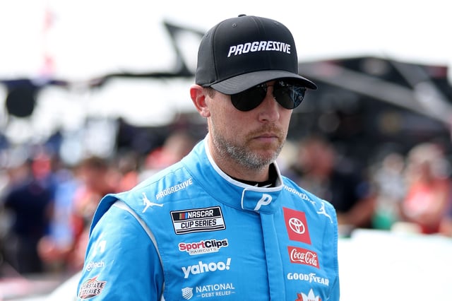 Denny Hamlin, driver of the #11 Progressive Toyota, walks the grid the NASCAR Cup Series The Great American Getaway 400 at Pocono Raceway on June 22, 2025 in Long Pond, Pennsylvania.